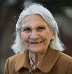 Gray-haired lady in a brown coat