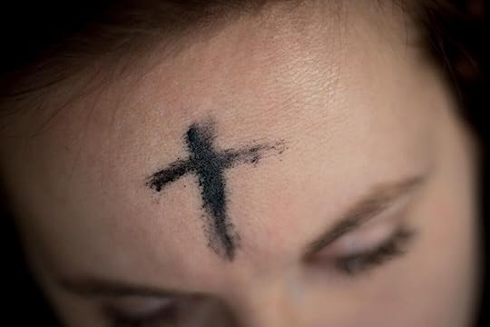black cross on person's forehead
