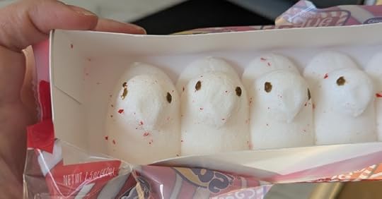 A bunch of white dove-shaped marshmallows that had red specks all over them.