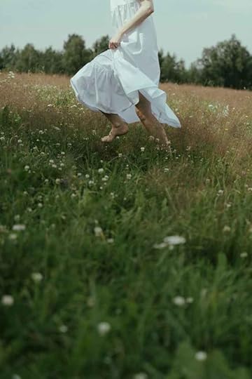 Current image: woman wearing white dress on a meadow