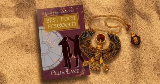 Copy of Best Foot Forward lying on a bed of sand, covered by an enamelled Horus medallion. The cover has a deep red background with map markings in a dull purple. Two men in silhouette stand, looking up at a point in the top left. An astrology chart with different symbols picked out takes up the left side of the image, with glowing stars curving up to the title.