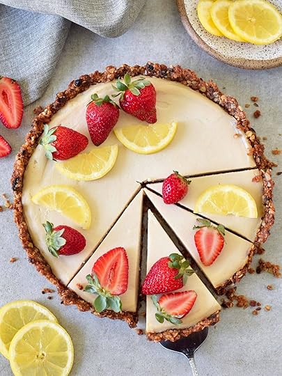 top shot of vegan lemon tart decorated with strawberries lemon slices