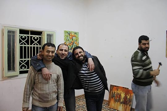 Eltiqa members (from right) Mohammed Al-Hawajri, Mohamed Dabous, Sohail Salem, and Raed Issa installing the <em>Liqa’</em> (Meeting) exhibition at the Eltiqa Gallery, Gaza, 2011<br />Courtesy Jameel Arts Centre, Dubai”>		</div>		<div class=