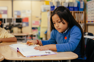 little girl reading a book