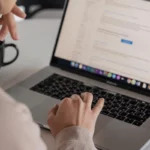 Person working on a laptop, browsing search engine results for an SEO company.