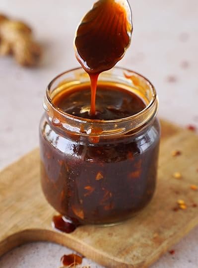 Korean bbq sauce in jar on wooden board with spoon
