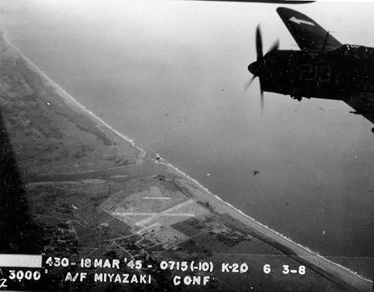 Strike photo taken by aircraft from USS Bunker Hill showing an SB2C Helldiver of Squadron VB-84 over Miyazaki Airfield on southern Kyushu, Japan, 18 Mar 1945 (National Museum of Naval Aviation)