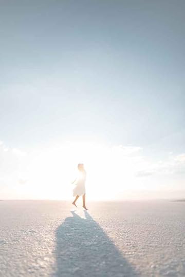 Current image: woman in dress posing on salt lake