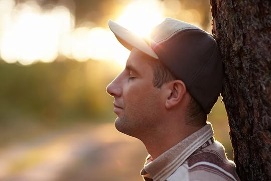 Image of a peaceful man resting his head against a tree. Begin learning how to regulate your emotions through DBT while at an adult IOP in Houston, TX.