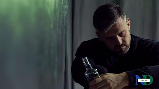 A man drinking on a green background.