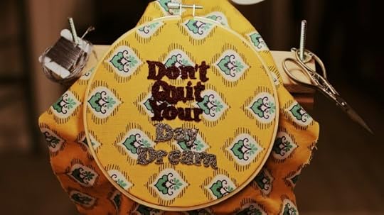 It will never be perfect. Needlepoint that reads “Don’t quit your day dream.”