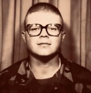 An Air Force recruit in uniform wearing glasses