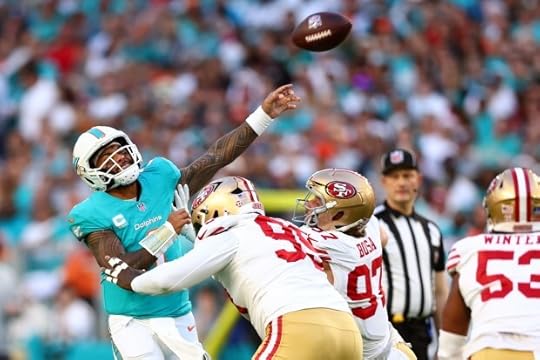 Tua Tagovailoa #1 of the Miami Dolphins throws a pass against Maliek Collins #99 and Nick Bosa #97 of the San Francisco 49ers during the first quarter at Hard Rock Stadium on Dec. 22, 2024 in Miami Gardens, Florida. (Photo by Megan Briggs/Getty Images)