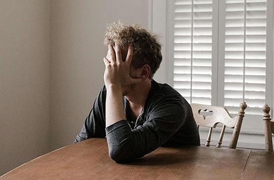 Image of a stressed man sitting at a table, resting his hand against his face. But the help of DBT IOP in Houston, TX you can begin managing your borderline personality disorder symptoms in positive ways.