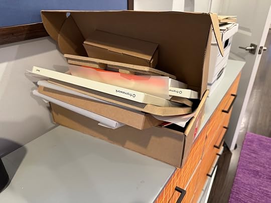 Photo of the packaging from the Framework laptop. It's a laptop-sized box open, containing many thinner cardboard boxes and protective sheets of compostable plastic.