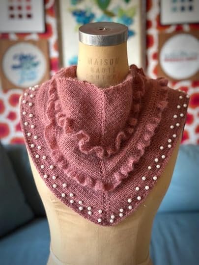 Rococo Bandit Scarf | Knitting pattern by Vickie HowellRococo Bandit is worked in Stockinette stitch, with added faux pearls or beads and stitches picked up with a single strand for the ruffles. The scarf utilizes a clever bind-off to prevent curling, giving it a professional, finished edge. 