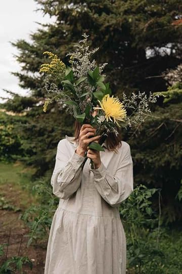 Current image: woman in dress holding flowers