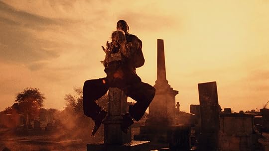 A corpse rides a gravestone in
