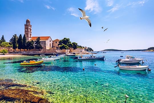 View at amazing archipelago with fishing boats in front of town Hvar, Croatia. Harbor of old Adriatic island town Hvar with seagull's flying over the city. Amazing Hvar city on Hvar island, Croatia