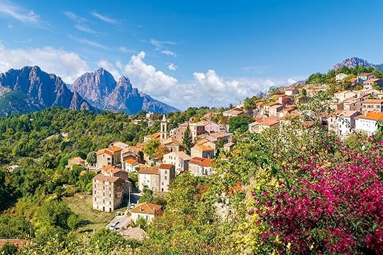 Evisa, Corsica, a picturesque hillside village with red-roofed houses, vibrant flowers, and stunning mountain views