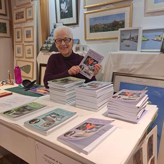 photo of Linda Alvis in her studio with all three of her travel memoirs