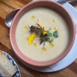 roasted cauliflower soup in a brown bowl