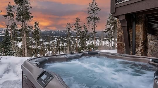 hot tub overlooking snowy mountains
