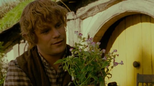 Sam Gamgee marvels over flowers in a still from Lord of the Rings: The Fellowship of the Ring.