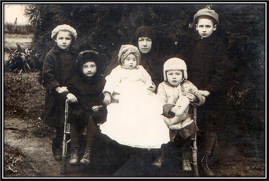 Grandmother dressed in mourning surrounded by her five grandchildren. They are in exile from their homeland.