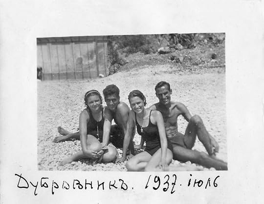 Old photo of two young women and two young men wearing bathing suits on a beach in nineteen thirty-seven.