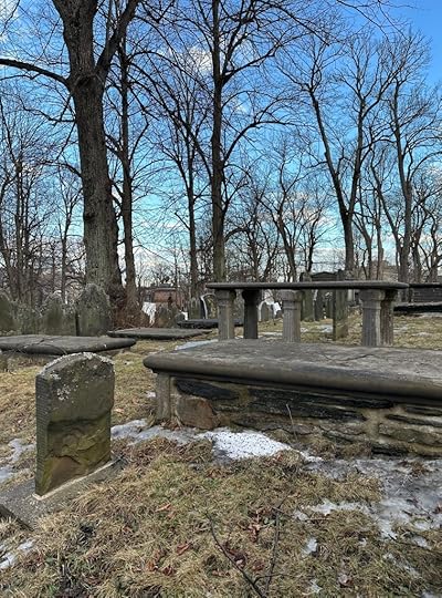 Gravestones, trees, blue sky