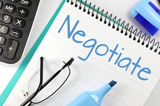 Negotiate written on a tablet with a blue marker. Eyeglasses are lying on the tablet with the marker.