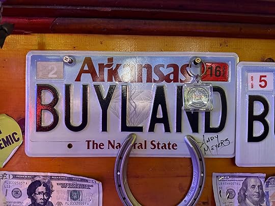 a license plate with a horseshoe and money