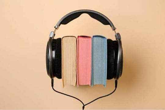 three books pressed together with headphones