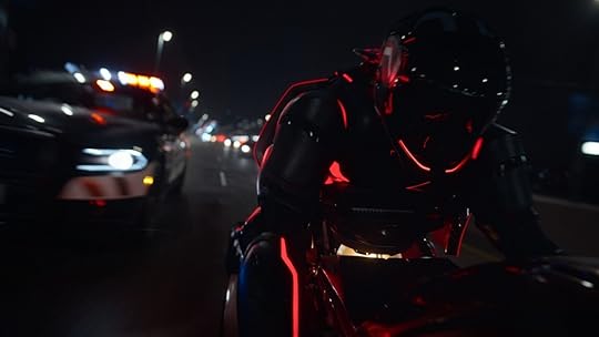 A red light cycle flees a real police car in the trailer for Tron: Ares