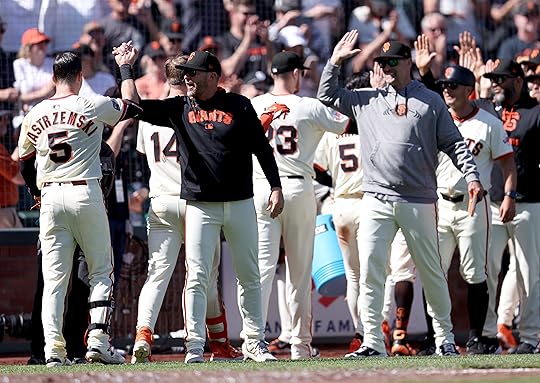 San Francisco Giants’ Mike Yastrzemski #5 is congratulated by coaches...
