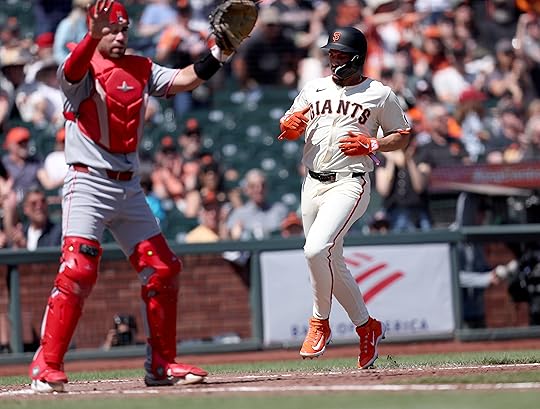 San Francisco Giants’ Willy Adames #2 scores past Cincinnati Reds...