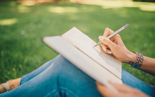 woman writing in a park