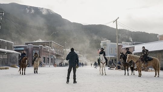 People on horseback being given orders against the backdrop of a commune in winter on The Last of Us