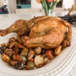 The finished Greek-Inspired Roast Chicken on a bed of vegetables