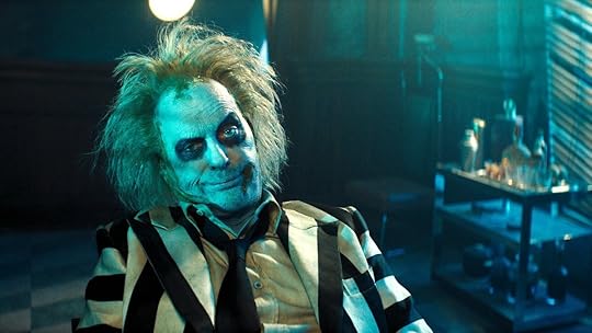 Michael Keaton smirking as the pale ghost Beetlejuice
