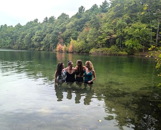 Four women standing in Walden Pond