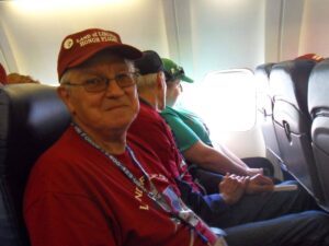 A man sitting in a seat on an airliner