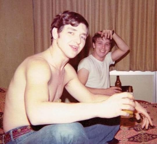 Two young men relaxing and having something to drink