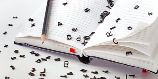 Black letters spilling out of an open notebook with pencil