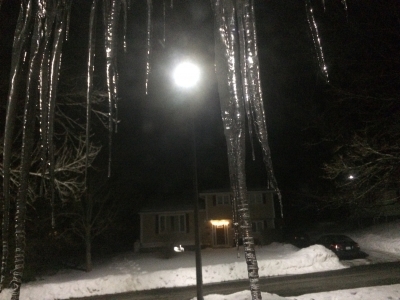 The moon shines through icicles