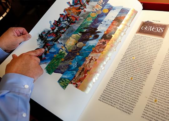 The St. John's Bible is open to a colorful illustraiont with a hand and finger pointing to the first image on the page.