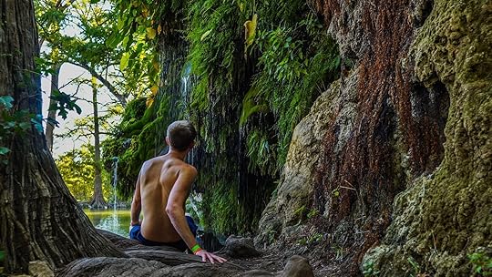 man sitting by kraus spring at spicewood springs, texas