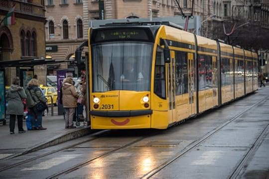 A yellow tram with a smiling mouth decal.