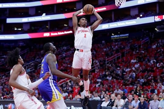 Houston Rockets forward Amen Thompson (1) dunks over Golden State Warriors forward Draymond Green, center, and Rockets guard Jalen Green, left, during the first half of an NBA basketball game Thursday, April 4, 2024, in Houston. (AP Photo/Michael Wyke)